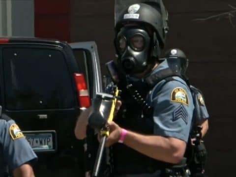 shows a St. Paul police officer in riot gear